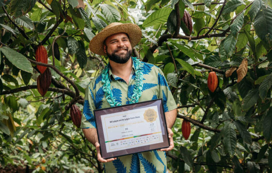 A man holding an award for chocolate making.